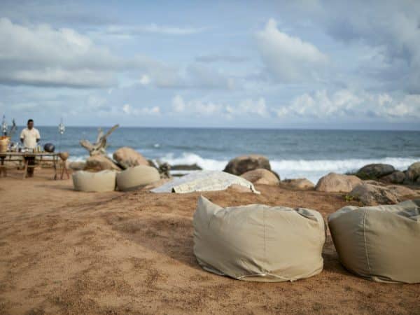 Wild Coast Lodge - Wild Coast Tented Lodge is adjacent to Yala National Park, renowned for its leopard population. This spectacular luxury tented camp is situated on a rugged, empty beach, overlooking the Indian Ocean. The unique design sees the man-made structures blending seamlessly into the surrounding landscape, thanks to the use of carefully selected natural materials. The use of arched fabric structures allows each of the 28 tents to take on the shape and color of the rocks and boulders that lay scattered nearby, whilst a clever layout in the shape of a leopard’s paw print alludes to the area’s most famous resident. The open-air bamboo-clad Ten Tuskers bar and Dining Pavilion – designed to mirror the boulders scattered across the golden beach beyond – wrap around the resort’s enormous free-form swimming pool. Guests can enjoy creative daily-changing menus of authentic Sri Lankan cuisine in the restaurant, as well as sundowner cocktails and picnics al fresco on the sand dunes, watching dusk settle over the Indian Ocean.